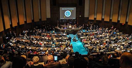 Policy meeting in an auditorium.